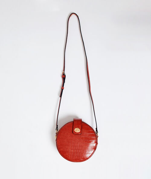 Round shaped bag in croc effect rust.